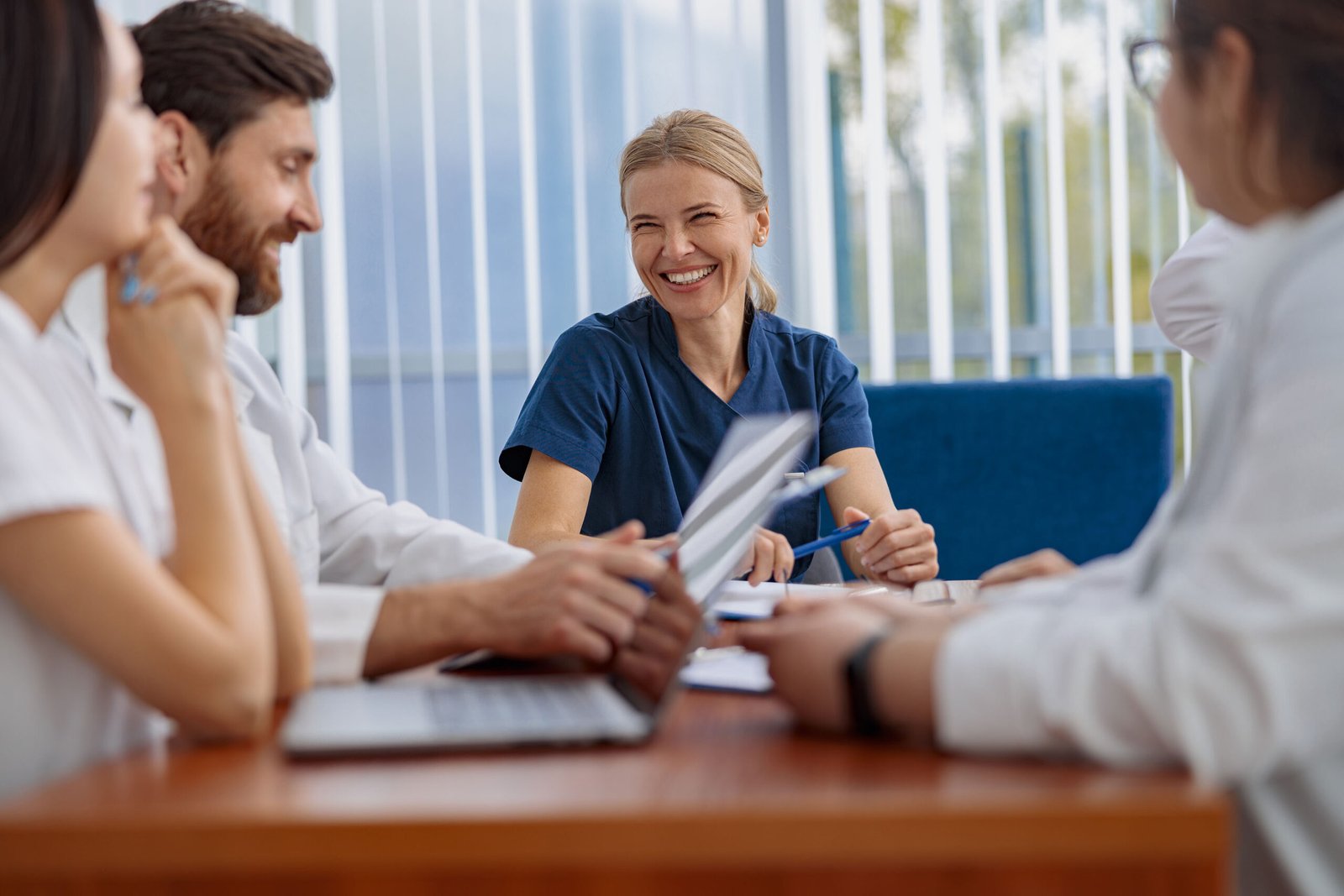 group of doctors talking sitting at a table in the office of the hospital