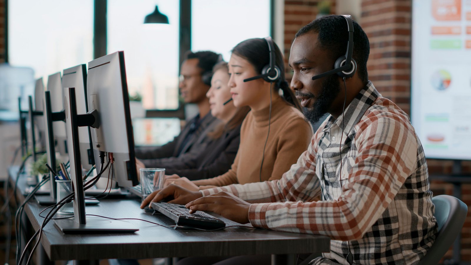 Approach african american man working at call center office